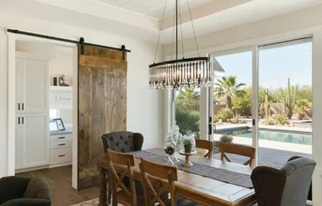 Dining room with a sliding barn door and glass patio doors