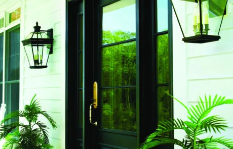Black entry door with a sidelight and carriage lanterns