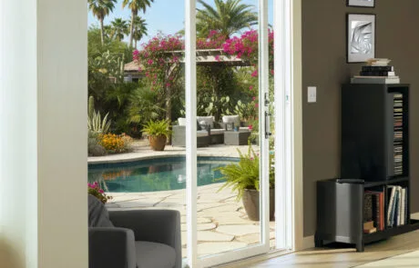 Sliding glass door leading from a den to a pool patio