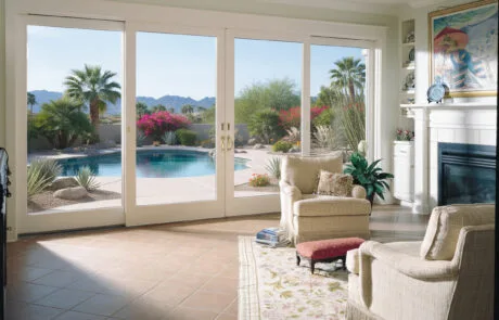 White French doors opening to a pool from a living room