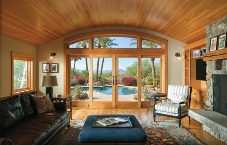 Arched wood patio doors in a room with a wood ceiling