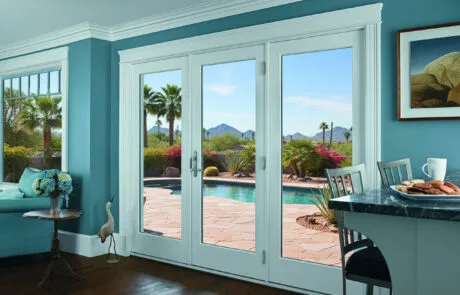 White French doors opening onto a patio from a dining area