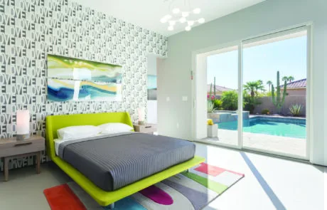 Bedroom with a sliding glass door opening to a pool