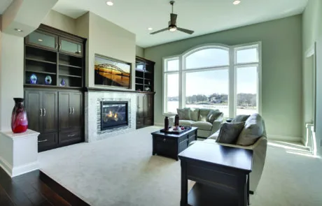 Living room with arched windows and a fireplace