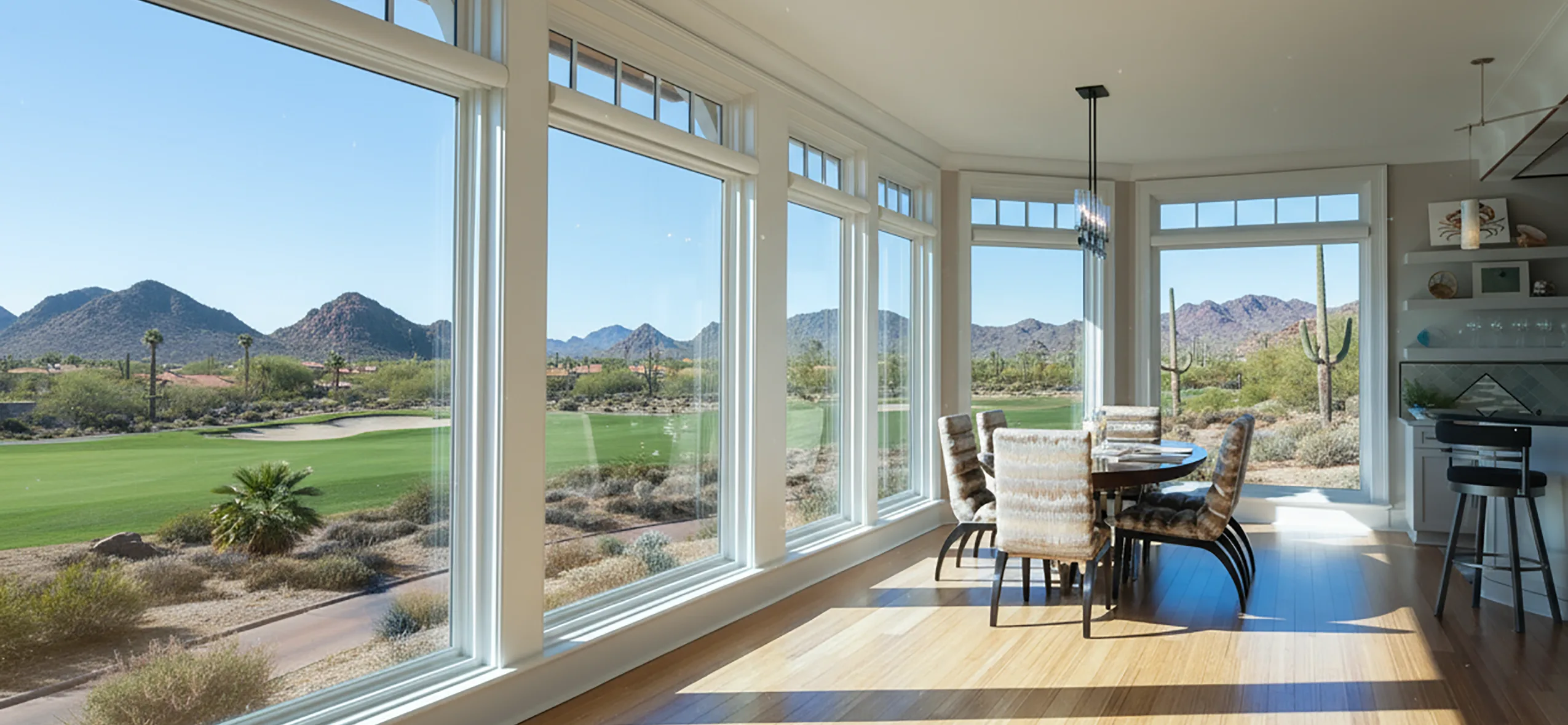 Wall of windows overlooking a desert golf course