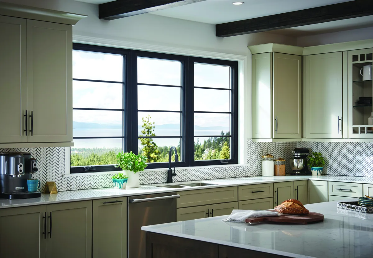 Kitchen with a run of black-framed casement windows over the sink