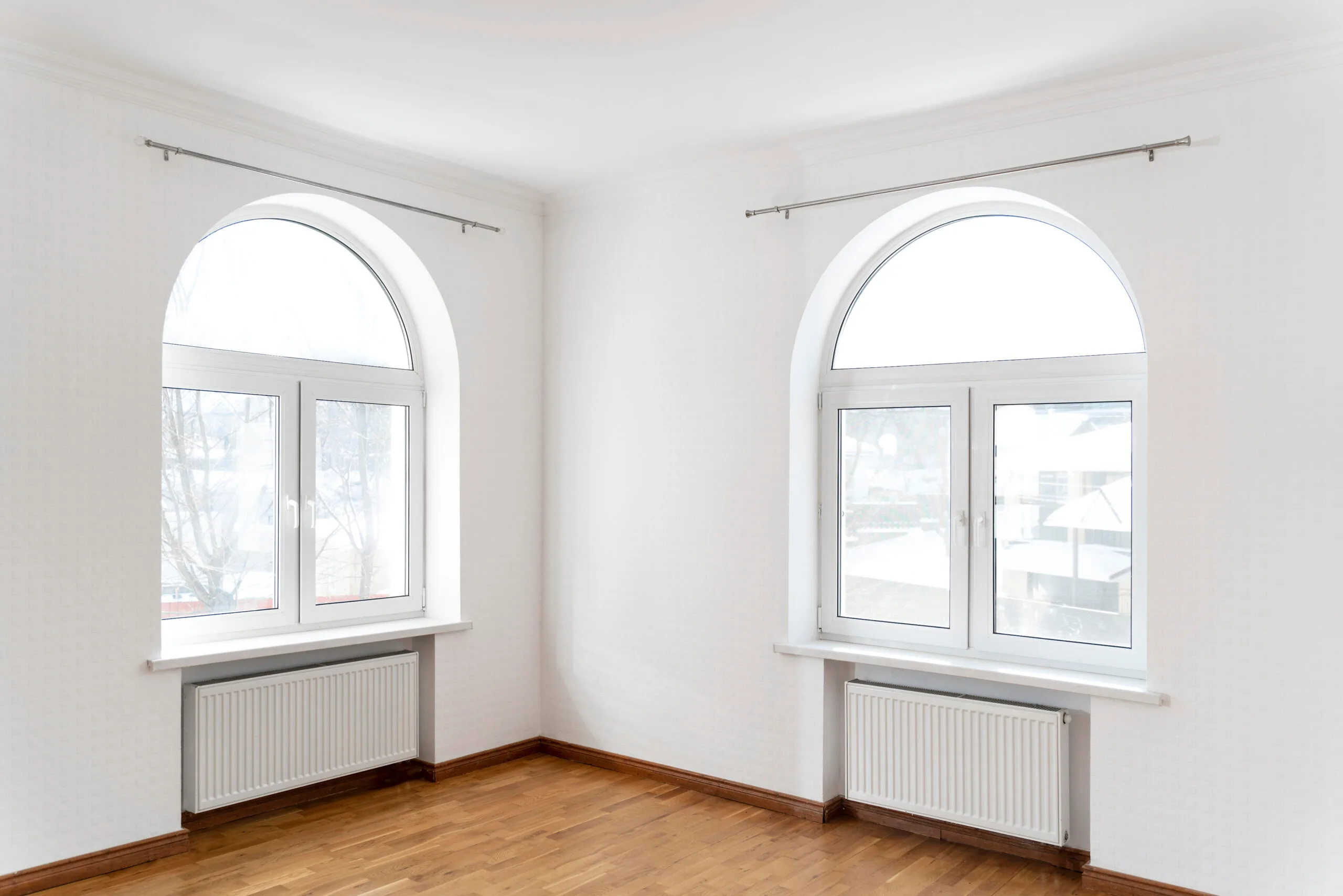 Large arched replacement windows bringing natural light into a home
