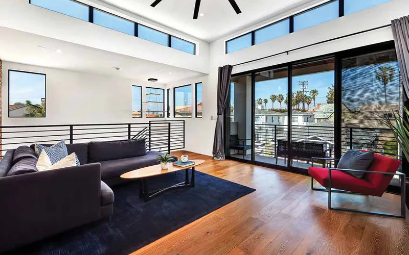 Living room with IWC 8800 Series Ambassador aluminum windows and a sliding door in dark frames