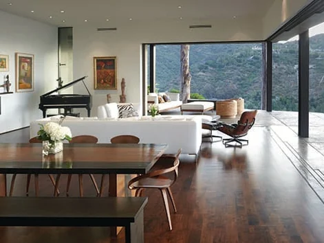 Sliding glass doors meeting at an open corner of a living room with a mountain view and no corner post