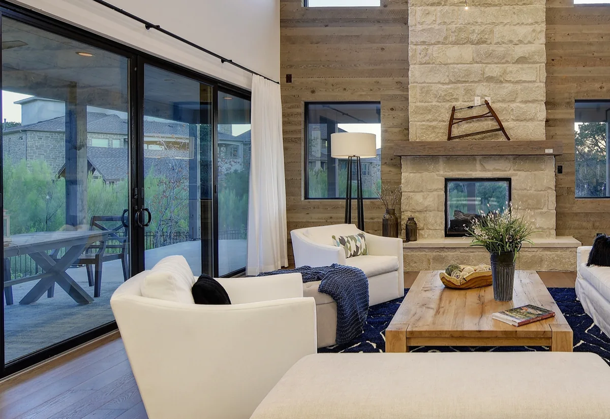 Black-framed multi-panel sliding glass doors along one wall of a vaulted great room