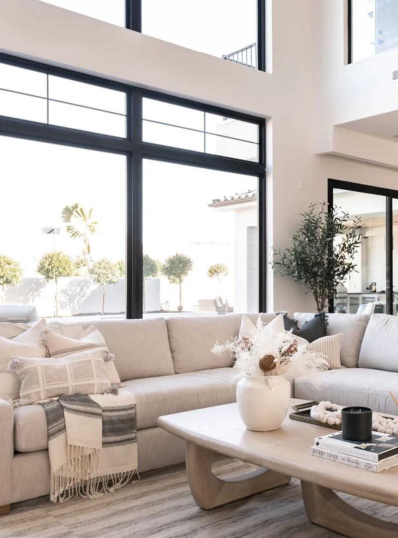 Great room with a tall black-framed glass wall after a style-first window upgrade