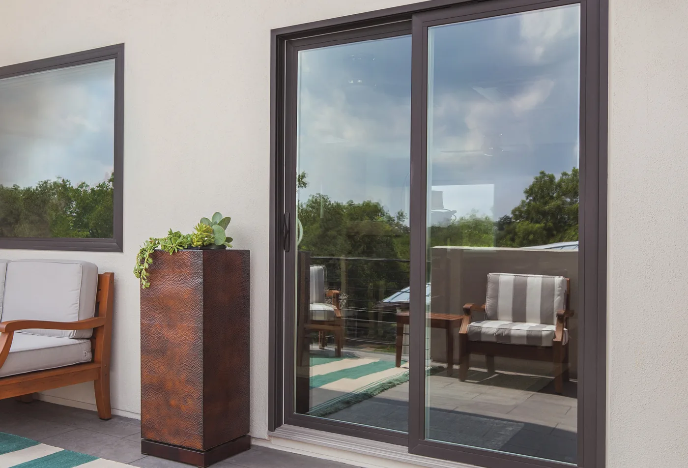 Two-panel sliding glass door with one fixed panel and one sliding panel, opening from a living room onto a patio