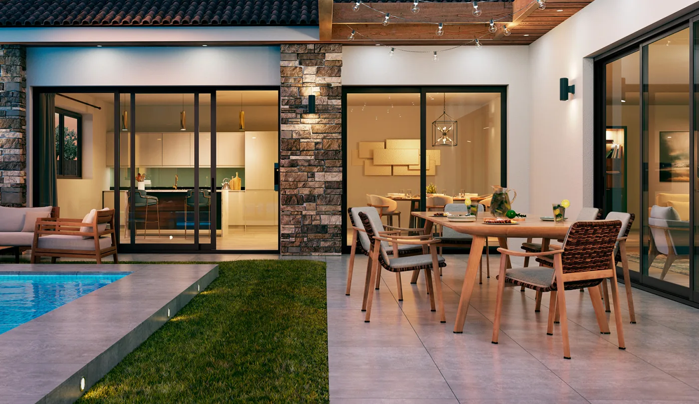 Stacking multi-slide door with its panels parked against each other at one side of the opening, on a covered patio at dusk