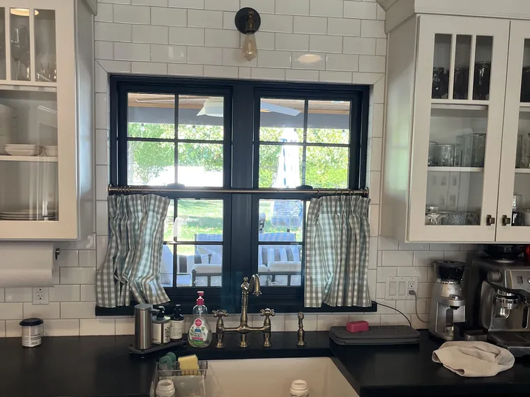 Kitchen of a finished Phoenix home with black framed French doors above a farmhouse sink