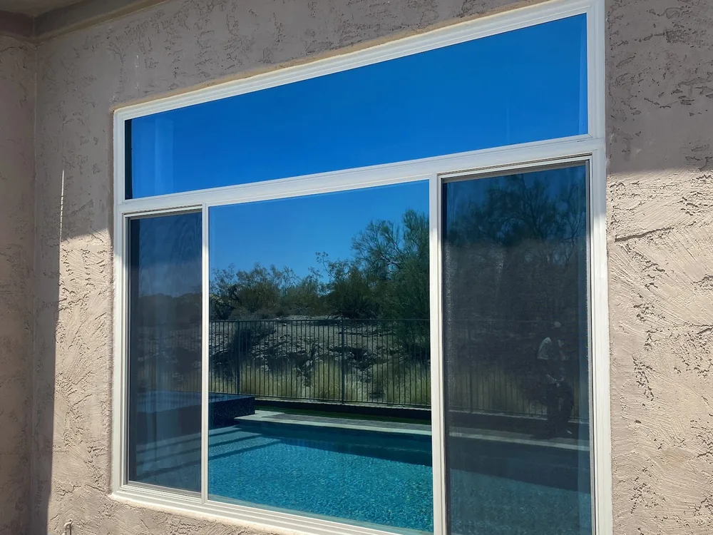 Large picture window beside a sliding unit looking onto a pool, a Noble project in the Phoenix area