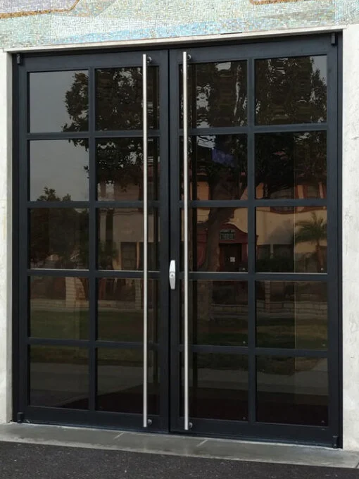 Pair of PRL Glass Systems black aluminum doors with divided glass and a full-height pull on each panel