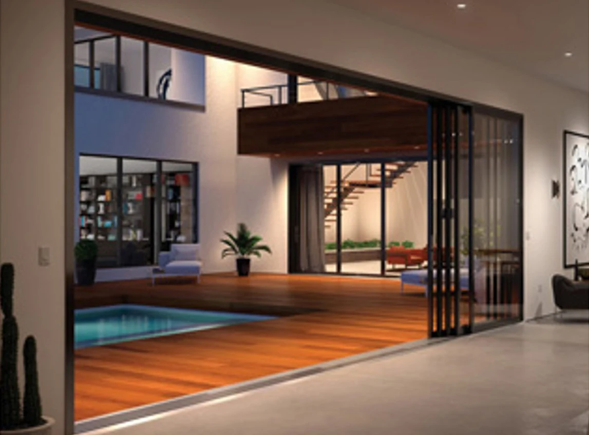 Multi-panel sliding glass door with every panel stacked at the right jamb, opening a room onto a courtyard pool
