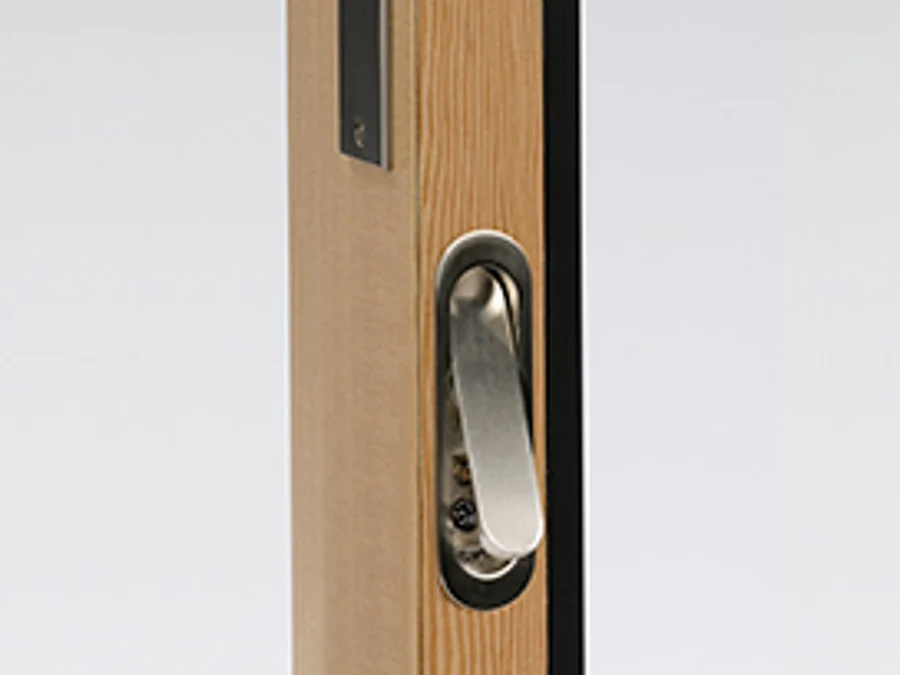 Spring-return edge pull flipped out of the edge of a wood stacking door panel