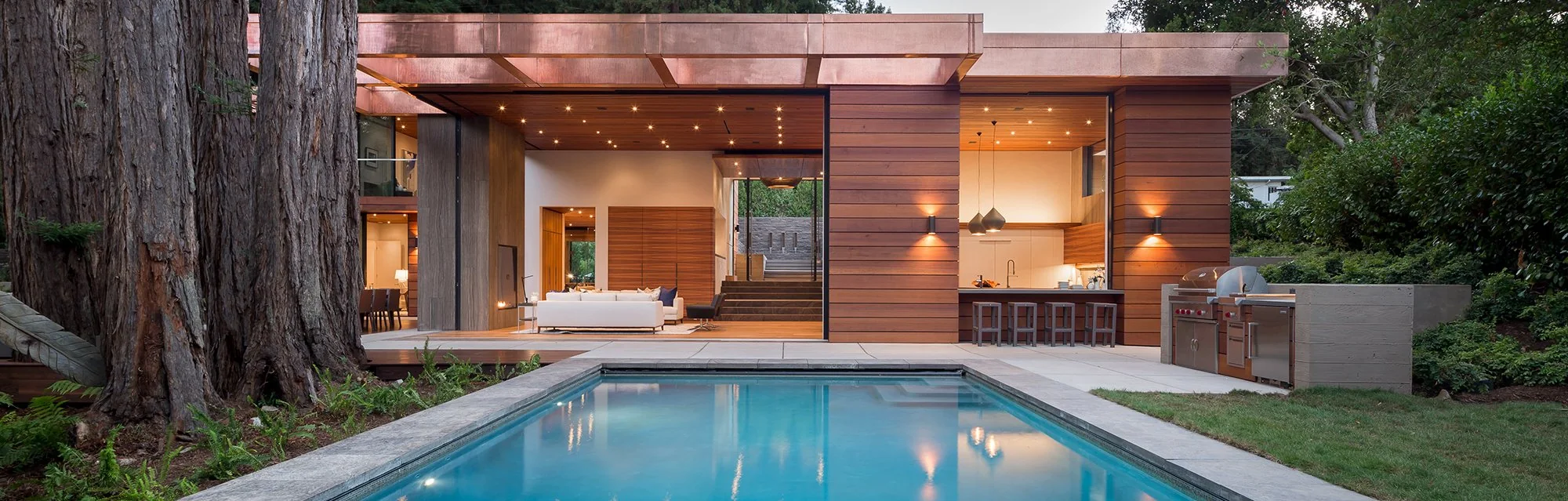 Pool pavilion with its sliding glass panels pocketed into the walls, leaving the whole opening clear