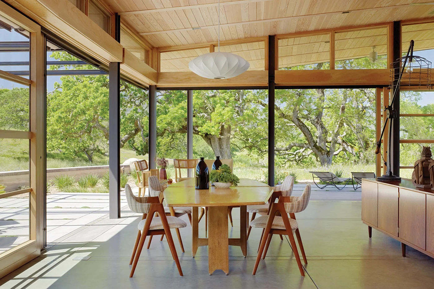 Stacking glass door open inside a great room with the panels parked against the left jamb